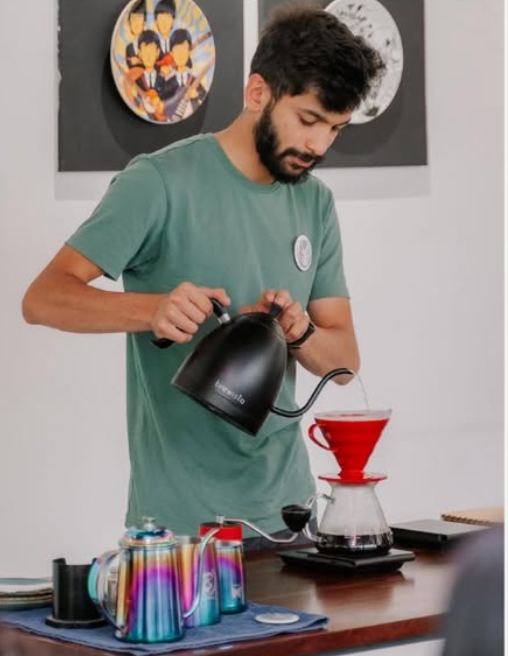 Anish Kale, coffee educator at Homemade Barista, brewing a pour-over coffee
